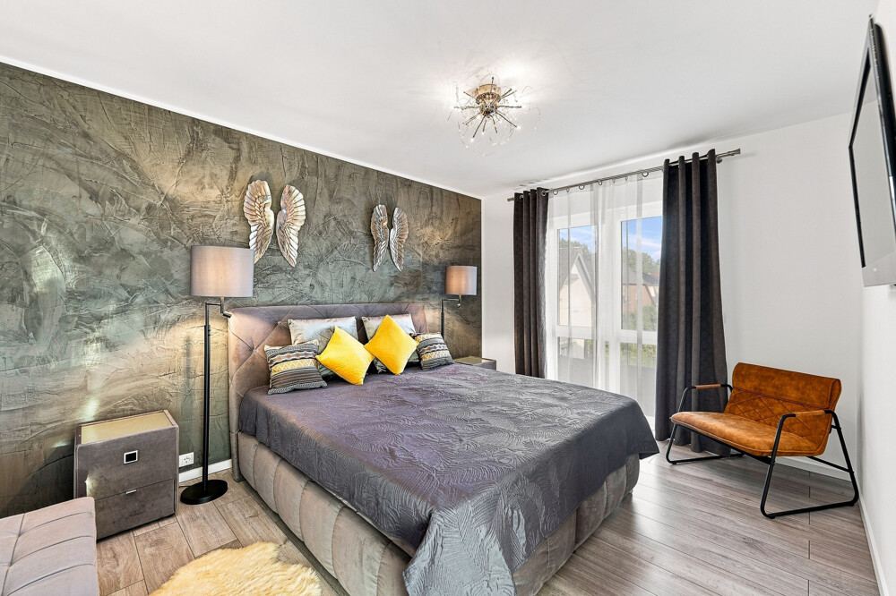 Elternschlafzimmer des Stadthauses in Bad Bramstedt mit Doppelbett und Fenster zur Gartenseite.