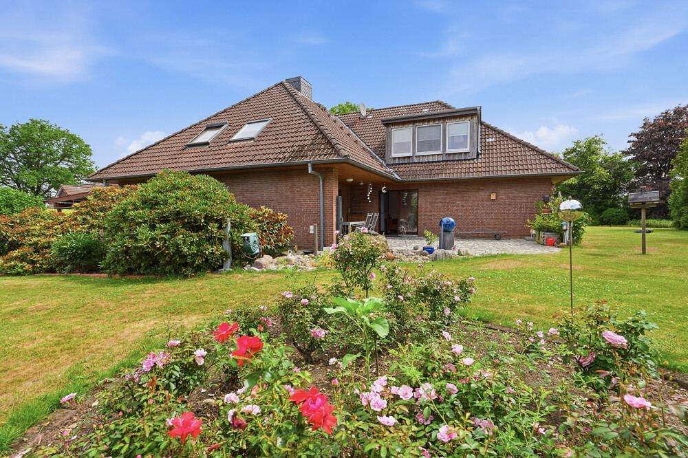Gartenseite mit Rosenbeet des Einfamilienhauses in Quarnstedt.